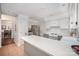 Bright kitchen featuring white cabinets, stainless steel appliances, and a convenient breakfast bar at 1014 Covewood Ct, Charlotte, NC 28270