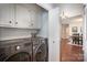 Convenient laundry room area with modern washer and dryer units and storage cabinets at 1014 Covewood Ct, Charlotte, NC 28270