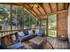 Relaxing screened porch with wooden ceiling, comfortable blue seating, and tranquil backyard view at 1014 Covewood Ct, Charlotte, NC 28270