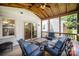 Covered porch featuring wood ceiling, comfortable seating, and a seamless indoor-outdoor living experience at 1014 Covewood Ct, Charlotte, NC 28270