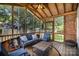 Relaxing screened porch with wooden ceiling, comfortable blue seating, and tranquil backyard view at 1014 Covewood Ct, Charlotte, NC 28270