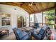 Covered porch featuring wood ceiling, comfortable seating, and a seamless indoor-outdoor living experience at 1014 Covewood Ct, Charlotte, NC 28270