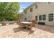 Home's backyard features an outdoor dining table, built-in fire pit and professionally installed brick pavers at 1016 Spanish Moss Rd, Indian Trail, NC 28079