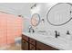 Bright bathroom featuring double sinks, round mirrors, modern fixtures, and a shower with a curtain at 1016 Spanish Moss Rd, Indian Trail, NC 28079