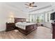 Spacious primary bedroom with tray ceilings, hardwood floors and natural light from bright windows at 1016 Spanish Moss Rd, Indian Trail, NC 28079
