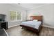 Cozy bedroom features a large window and comfortable bed on hardwood floors at 1016 Spanish Moss Rd, Indian Trail, NC 28079