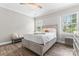 Cozy bedroom with wood flooring, soft natural light, and an inviting double bed at 1016 Spanish Moss Rd, Indian Trail, NC 28079