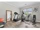 Exercise room with a treadmill, elliptical machine, weight bench, hardwood floors, and large mirror at 1016 Spanish Moss Rd, Indian Trail, NC 28079