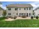 Home's exterior featuring a brick patio, seating area, manicured lawn, and backyard at 1016 Spanish Moss Rd, Indian Trail, NC 28079