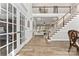 Lovely foyer with a staircase, French doors, hardwood flooring, and a view into the living room at 1016 Spanish Moss Rd, Indian Trail, NC 28079