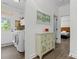 Hallway featuring cabinet with decor, laundry room entrance, and view of the bedroom at 1016 Spanish Moss Rd, Indian Trail, NC 28079