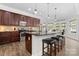 Modern kitchen with dark cabinetry, granite countertops, island with seating, and stainless-steel appliances at 1016 Spanish Moss Rd, Indian Trail, NC 28079