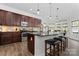 Beautiful kitchen featuring dark wood cabinets, stainless appliances and granite countertop island with pendant lights at 1016 Spanish Moss Rd, Indian Trail, NC 28079