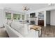Inviting living room with a stone fireplace, built-in shelving, and white couches at 1016 Spanish Moss Rd, Indian Trail, NC 28079
