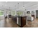 Spacious open-concept living area with an adjacent dining area, kitchen and beautiful fireplace feature at 1016 Spanish Moss Rd, Indian Trail, NC 28079