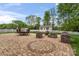 Outdoor patio with brick pavers, outdoor dining set, fire pit, and landscaping at 1016 Spanish Moss Rd, Indian Trail, NC 28079