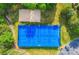Four tennis courts are surrounded by a high fence and greenery with a beach volleyball court nearby at 1016 Spanish Moss Rd, Indian Trail, NC 28079