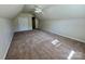 An attic with neutral carpeting, a ceiling fan, and an alcove at 1043 Cambrook Ct, Concord, NC 28027