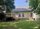 Home backyard featuring a wooden deck, steps, green lawn, and a light siding exterior at 1043 Cambrook Ct, Concord, NC 28027