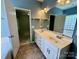 Bright, full bathroom with double vanity, tiled floors, and glass enclosed shower plus separate bathtub at 1043 Cambrook Ct, Concord, NC 28027