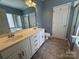 Bathroom featuring dual sinks, a bathtub, a separate shower, a tiled floor, and a decorative light fixture at 1043 Cambrook Ct, Concord, NC 28027