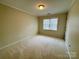 Cozy bedroom featuring neutral walls, plush carpeting, and a bright window for lots of natural light at 1043 Cambrook Ct, Concord, NC 28027