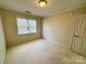 Inviting bedroom with plush carpet, neutral walls, a window, and a closet perfect for relaxation at 1043 Cambrook Ct, Concord, NC 28027