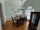 Bright dining room with hardwood floors, elegant lighting, and a window with natural light at 1043 Cambrook Ct, Concord, NC 28027