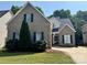 Charming two-story brick home with manicured lawn, black shutters, and a basketball hoop over the driveway at 1043 Cambrook Ct, Concord, NC 28027