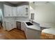 Well-designed kitchen boasting an island with breakfast bar, white cabinets, and stainless steel appliances at 1043 Cambrook Ct, Concord, NC 28027