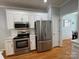 Modern kitchen featuring stainless steel appliances, white cabinets, and subway tile backsplash at 1043 Cambrook Ct, Concord, NC 28027