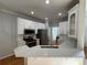 Stylish kitchen with quartz countertops, white cabinetry, stainless steel appliances, and hardwood floors at 1043 Cambrook Ct, Concord, NC 28027