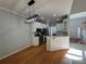 Bright kitchen with open layout to living area with white cabinets, stainless appliances, and stylish pendant lighting at 1043 Cambrook Ct, Concord, NC 28027