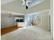 Bright living room featuring high ceilings, staircase, and open layout flowing into the kitchen with modern appliances at 1043 Cambrook Ct, Concord, NC 28027