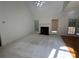 Bright living room with a fireplace, neutral carpet, and large windows offering natural light at 1043 Cambrook Ct, Concord, NC 28027
