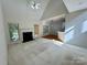 Spacious living room with fireplace, neutral carpeting, and open floor plan to kitchen with breakfast bar at 1043 Cambrook Ct, Concord, NC 28027