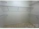 An organized walk-in closet with multiple tiers of wire shelving for optimal storage at 1043 Cambrook Ct, Concord, NC 28027