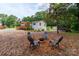 Backyard area with a fire pit, chairs, and wooden deck, creating a relaxing outdoor space at 10743 Ola Dr, Fort Mill, SC 29707