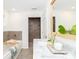 Modern bathroom with a soaking tub, walk-in shower, and dual sink vanity with stylish accents at 10743 Ola Dr, Fort Mill, SC 29707