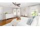 Bright bedroom with hardwood floors, white furniture, sheer curtains and stylish ceiling fan at 10743 Ola Dr, Fort Mill, SC 29707