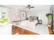 Inviting bedroom with hardwood floors, a cozy rug, and a comfortable bed with stylish pillows at 10743 Ola Dr, Fort Mill, SC 29707