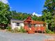Charming home with a wooden pergola deck and a gravel driveway surrounded by lush trees at 10743 Ola Dr, Fort Mill, SC 29707