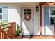Charming front door with a colorful wreath and 'hello' mat welcomes visitors to this home at 10743 Ola Dr, Fort Mill, SC 29707