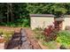 Lush garden beds with various plants and a garden shed enhance this property at 10743 Ola Dr, Fort Mill, SC 29707