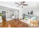 Bright living room with hardwood floors, ceiling fan, neutral paint, rugs, sofa, chairs, and windows at 10743 Ola Dr, Fort Mill, SC 29707