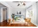 Bright living room featuring hardwood floors, ceiling fan, neutral paint, rug, sofa, and white trimmed windows at 10743 Ola Dr, Fort Mill, SC 29707