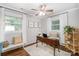 Home office featuring hardwood floors, desk, laptop, neutral paint, bench, and bright windows at 10743 Ola Dr, Fort Mill, SC 29707