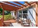 Inviting front porch featuring a wooden pergola, comfortable seating, and stylish decor at 10743 Ola Dr, Fort Mill, SC 29707
