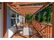 Inviting covered porch with wood pergola, chairs, and outdoor rug creates a relaxing outdoor space at 10743 Ola Dr, Fort Mill, SC 29707