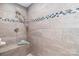 Luxurious tiled shower featuring a built-in bench and decorative mosaic accents at 10743 Ola Dr, Fort Mill, SC 29707